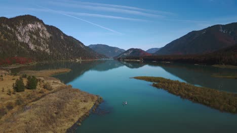 Stand-Up-Paddle-Boards-En-Sylvenstein-Speicher,-Pintoresco-Lago-Del-Embalse-Del-Río-Del-Valle-De-La-Montaña-Con-Agua-Azul-En-Los-Alpes-De-Baviera-Austria,-Fluyendo-Por-Un-Hermoso-Bosque-A-Lo-Largo-De-Los-árboles