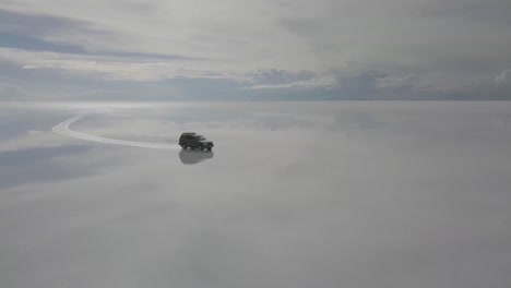 Toma-Aérea-De-Un-Vehículo-No-Tripulado-En-El-Salar-De-Uyuni-En-Bolivia-Con-Reflejo