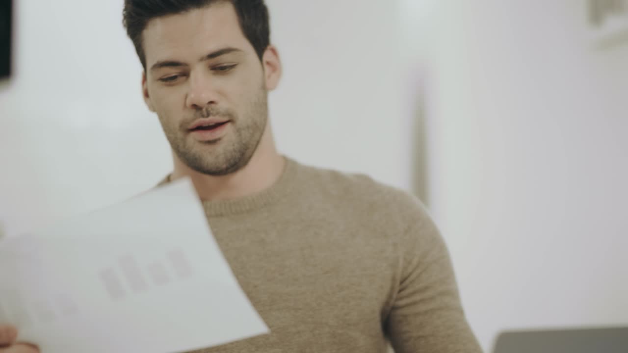 Happy white man working with documents at remote workplace.