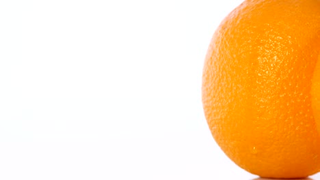 close-up rotation of orange on a white background