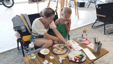 mother and daughter decorating cookies