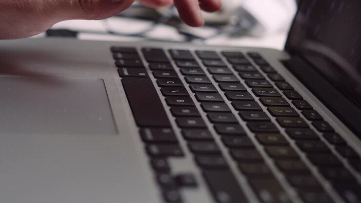 Male Hand Business Professional Typing on Laptop Keyboard Working from Home