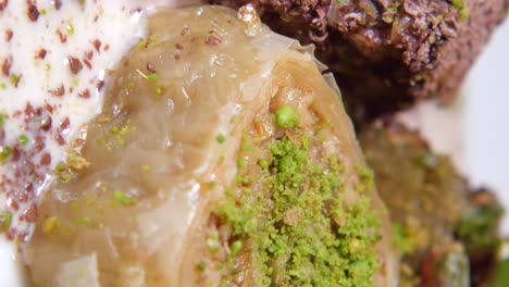 close-up of baklava with pistachios and cream