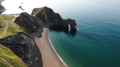 Aerial-Over-Durdle-Door-In-The-Morning-With-Calm-Turquoise-Waters