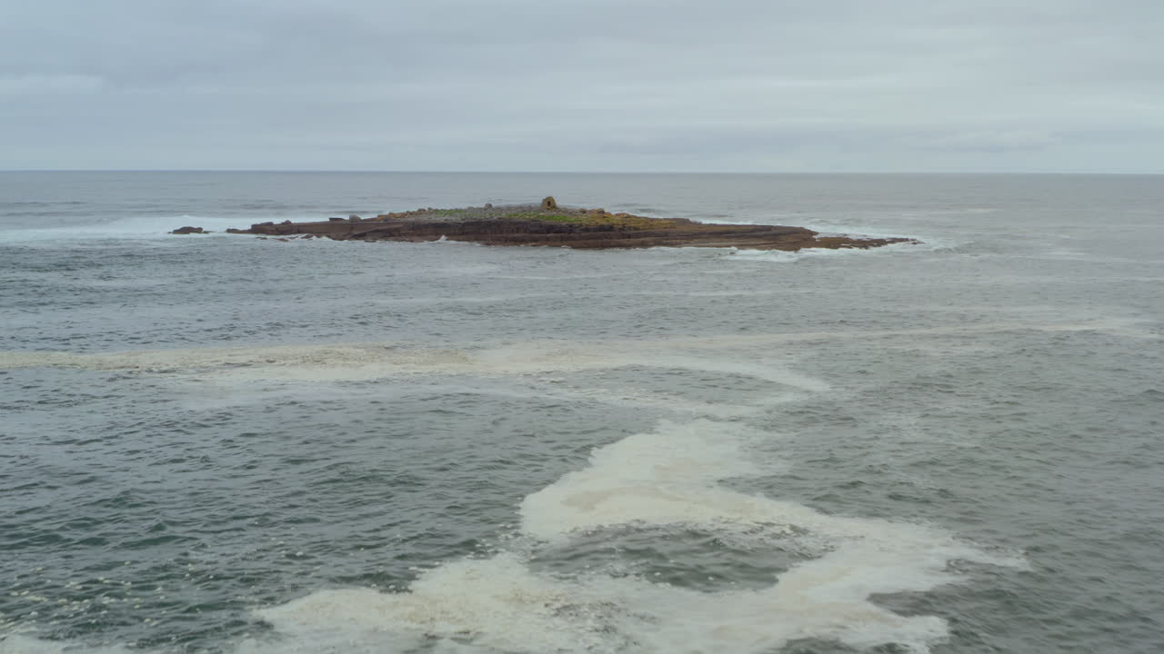 Aerial dolly shot over the Atlantic Ocean approaching Crab Island. County Clare, Ireland.