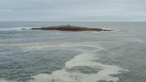 aerial dolly shot over the atlantic ocean approaching crab island. county clare, ireland.