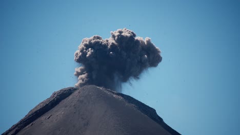 close up explosive fuego volcano eruption: rocks, ash clouds, and lava bombs create a dramatic spectacle