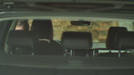 man looking at car