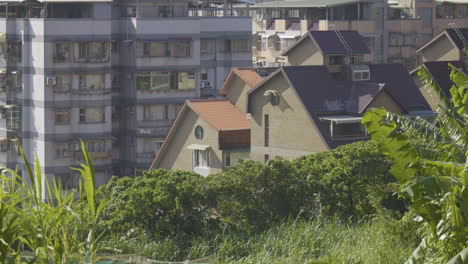 taiwan rural outskirts: villa and apartments beside green landscape