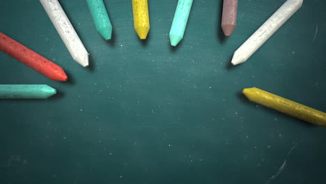 closeup colorful chalk on blackboard with school background