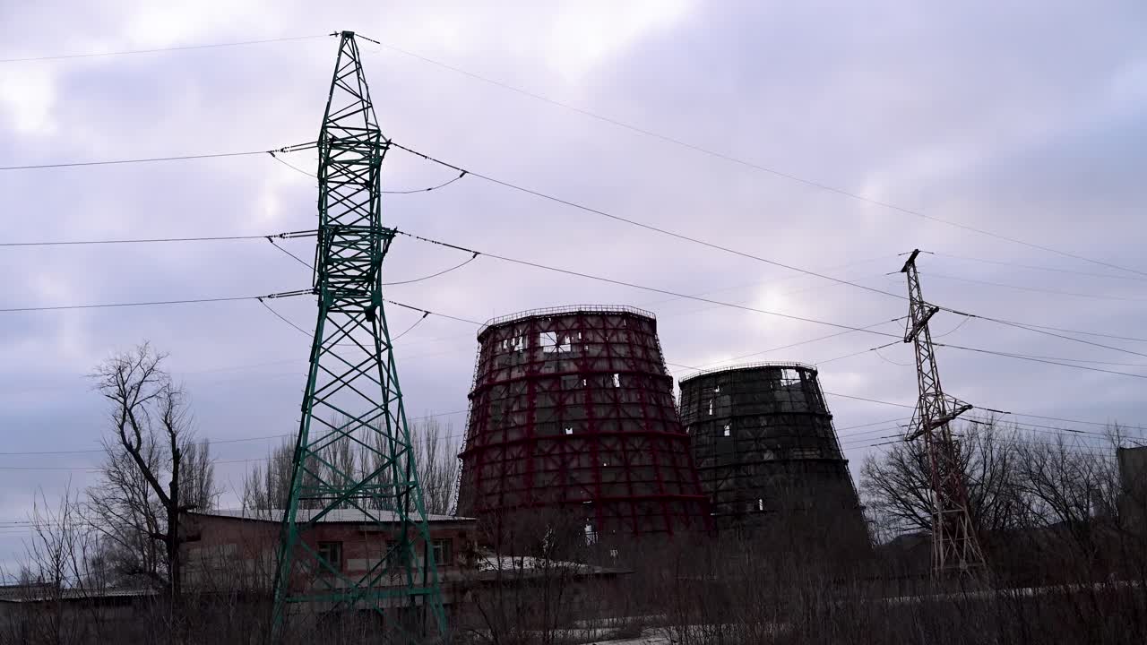 A power plant's cooling towers destroyed by a Russian missile strike in Kramatorsk, Ukraine. Dusk view of war-torn energy infrastructure on the Donbas frontline during the ongoing conflict