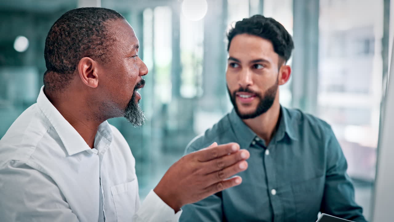 Two Diverse Businessmen Discussing Ideas in a Modern Office