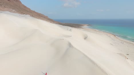 panoramic view of white sand dunes meeting a turquoise ocean coastline