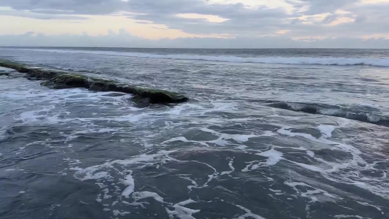 Onde marine tranquille che si infrangono su rocce costiere