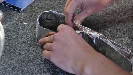 wrapping aluminum foil around a container