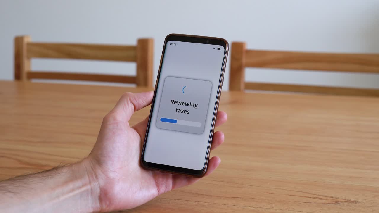 Reviewing taxes with smartphone app. Concept of online tax audit