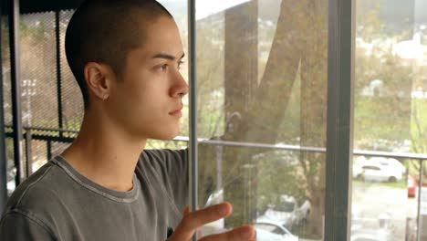 man standing near window at home 4k