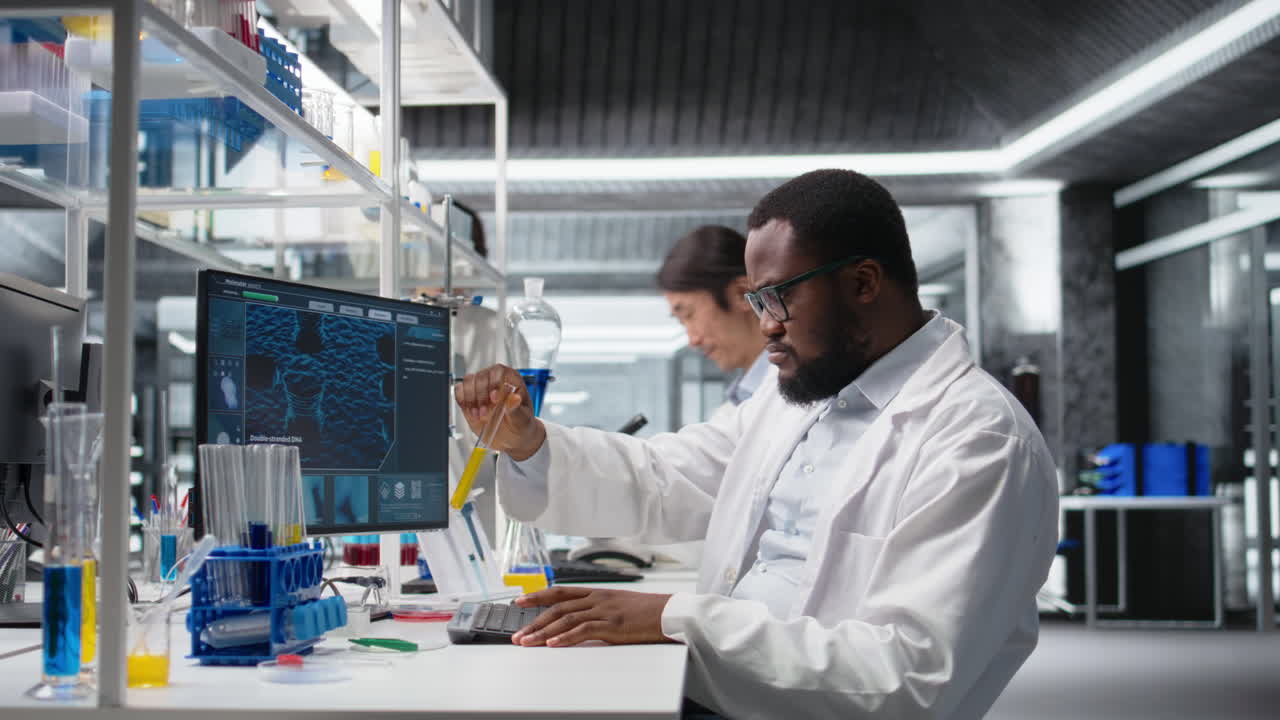 Vertical video Lab scientist evaluates genetic markers using PC, analyzing sample properties