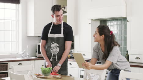 couple cooking together in kitchen