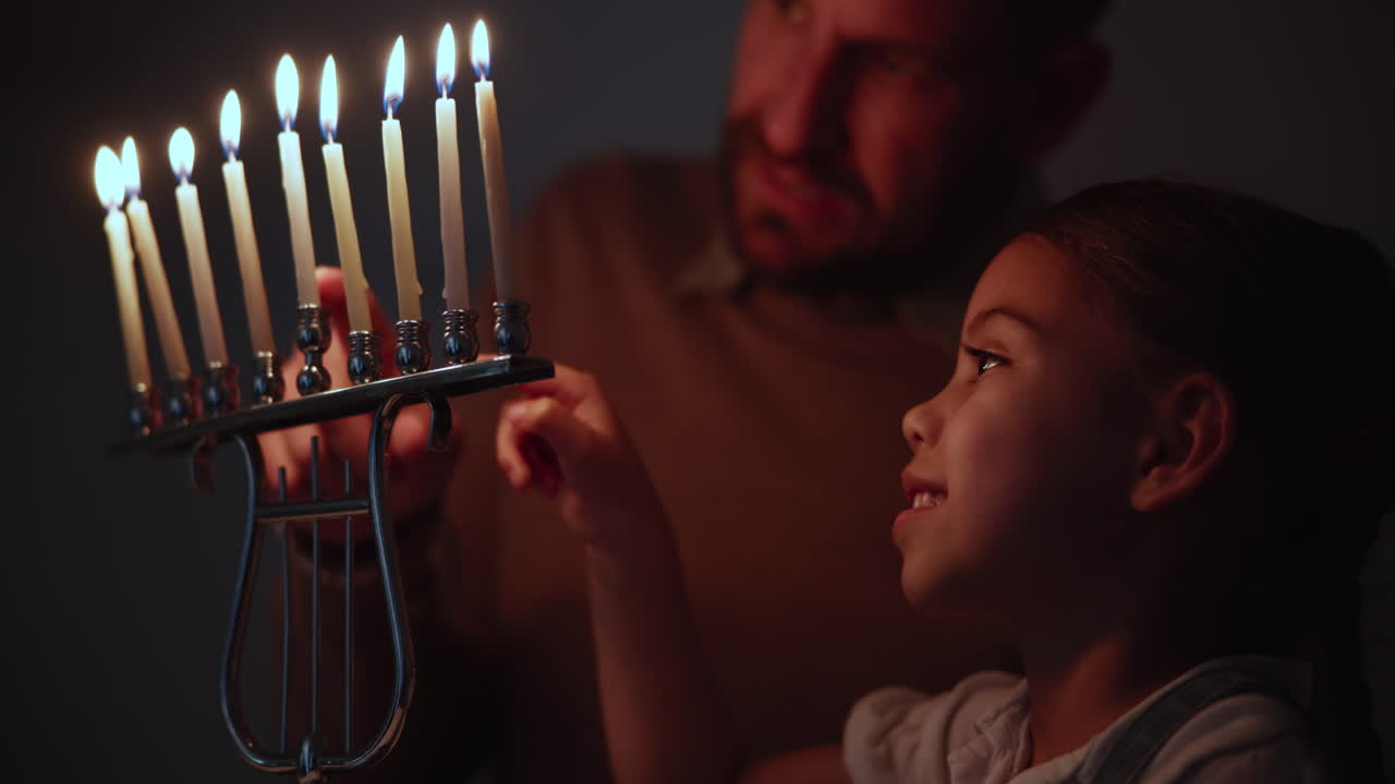 Jewish, tradition and a family lighting candles