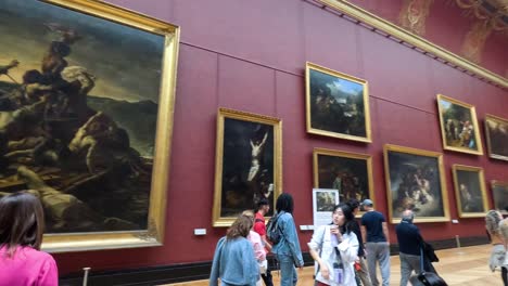 crowds admiring paintings in the louvre museum