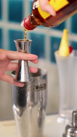 mixing ingredients for a cocktail at a bar