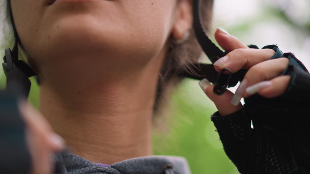 Rider Secures Helmet Strap Properly, Calm Outdoor Scene With Rider Adjusting Helmet And Straps Carefully, Detailed View Of Rider Ensuring Helmet Is Fastened Correctly Before Starting Ride
