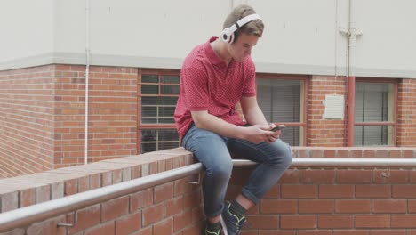 caucasian high school boy listening to music