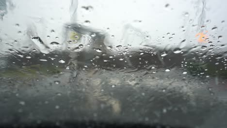 heavy rain, hale, hail on the windscreen making visibility poor and driving conditions dangerous and un predictable