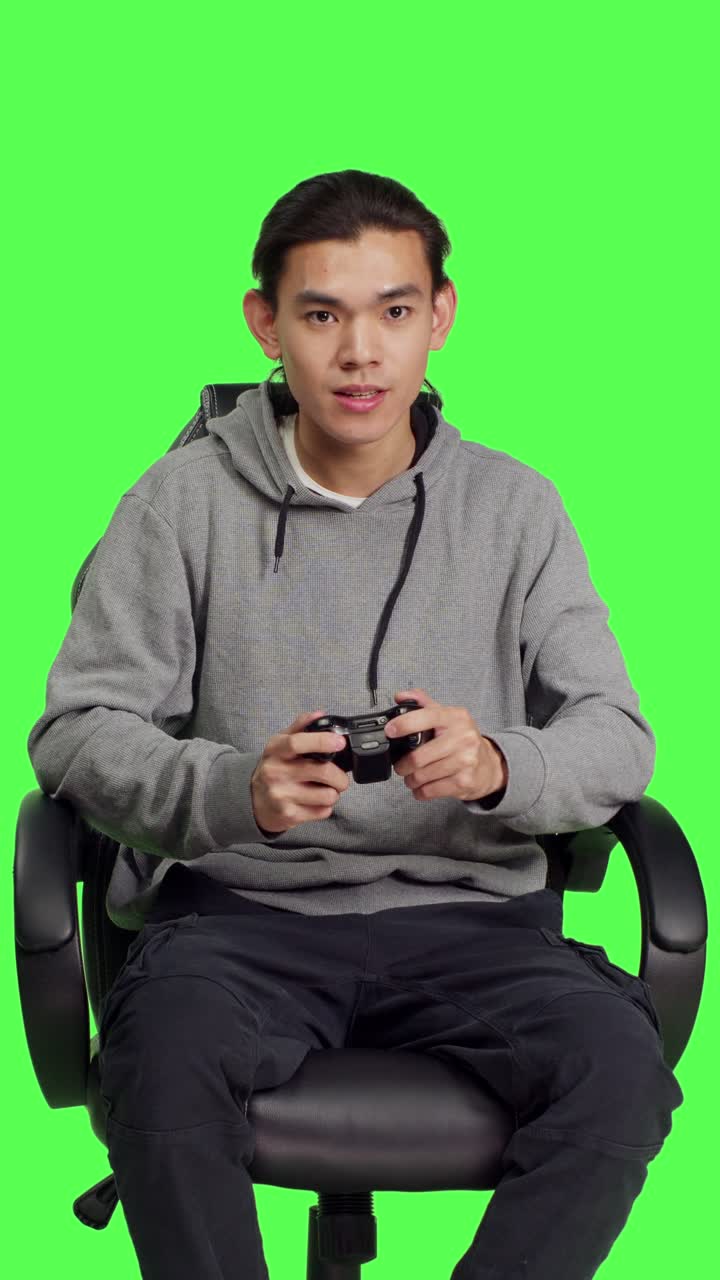 Front view of asian gamer playing video games
