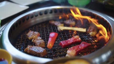 4k flames on yakiniku grill as japanese wagyu beef cooks away