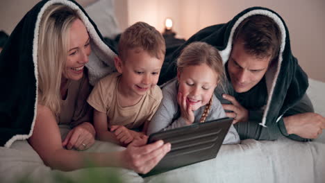 smile, tablet and family on a bed with a blanket