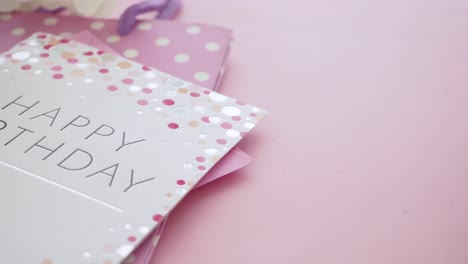 happy birthday card with pink gift bag and flowers