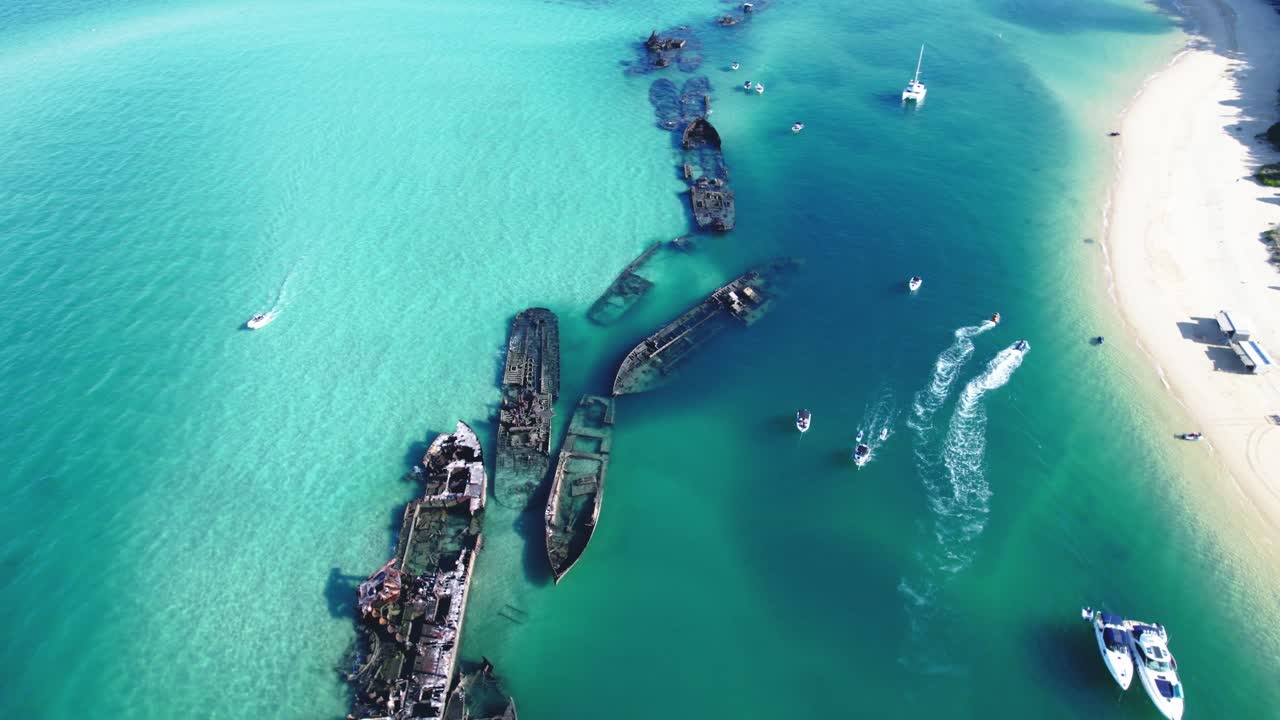 Crystal-clear waters surround Tangalooma Wrecks on Moreton Island, Australia.
