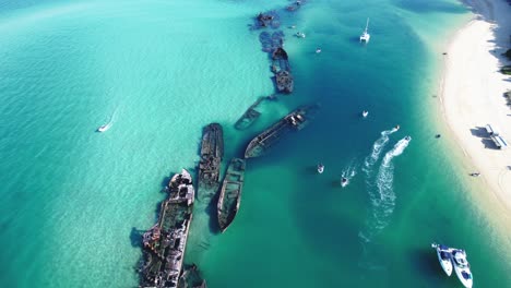 crystal-clear waters surround tangalooma wrecks on moreton island, australia.
