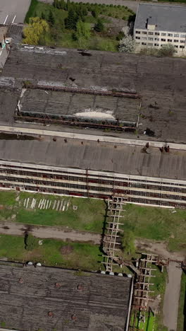 big abandoned territory of an old factory. ruined buildings of old industrial plant. aerial view. vertical video