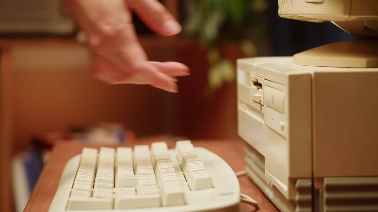 Woman inserting a floppy disk into a vintage computer