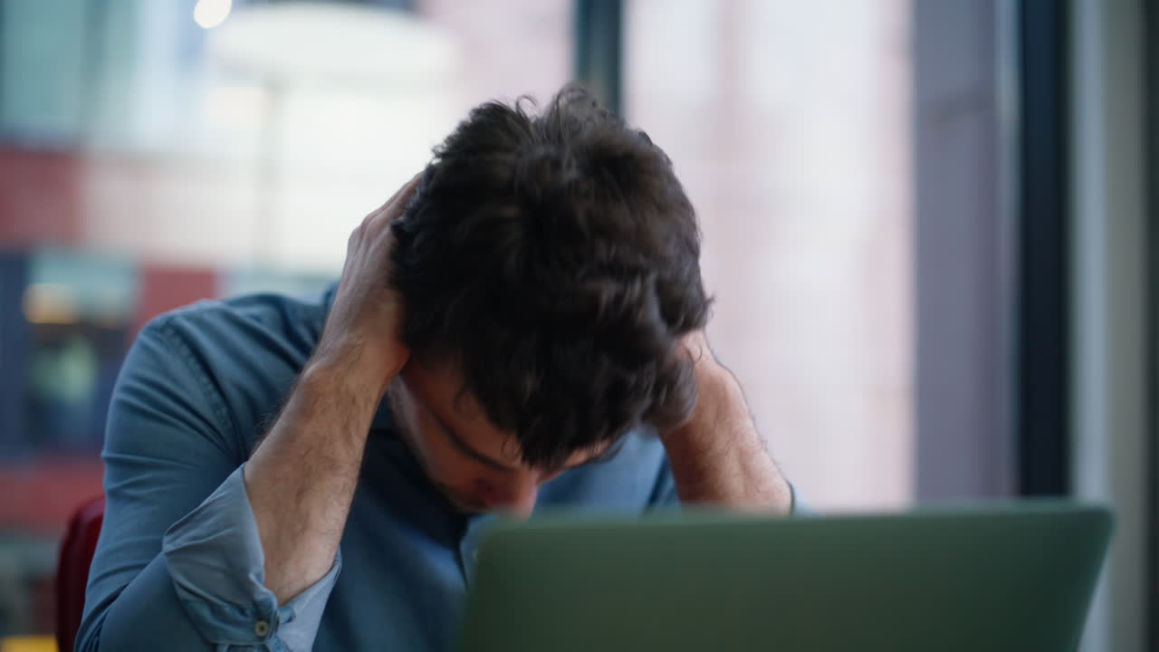 Freelancer worried phone call sitting home workplace closeup. Confused man