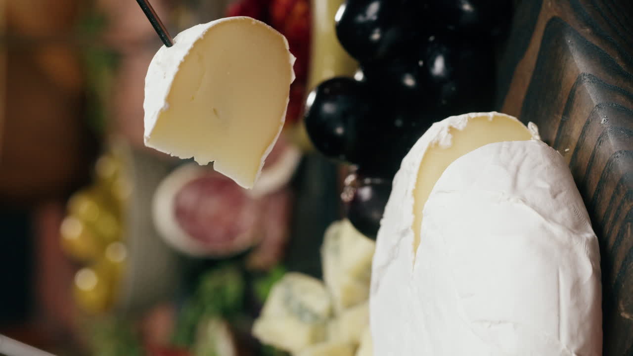 Close-up of charcuterie board with cheese, grapes, and berries