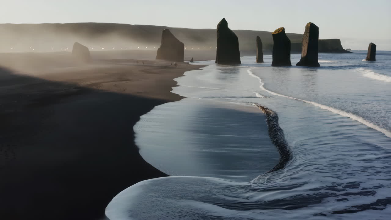 Black Sand Beach with Sea Stacks and Misty Coastline in Iceland