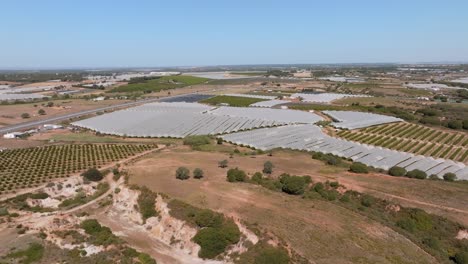 Wide-angle-aerial-overview-of-solar-farm-field-off-the-side-of-country-highway