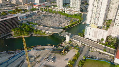 Bascule-bridge-over-river-in-city.-Opening-of--bridge-for-yacht-passage.-Tilt-up-reveal-high-rise-buildings-in-background.-Miami,-USA