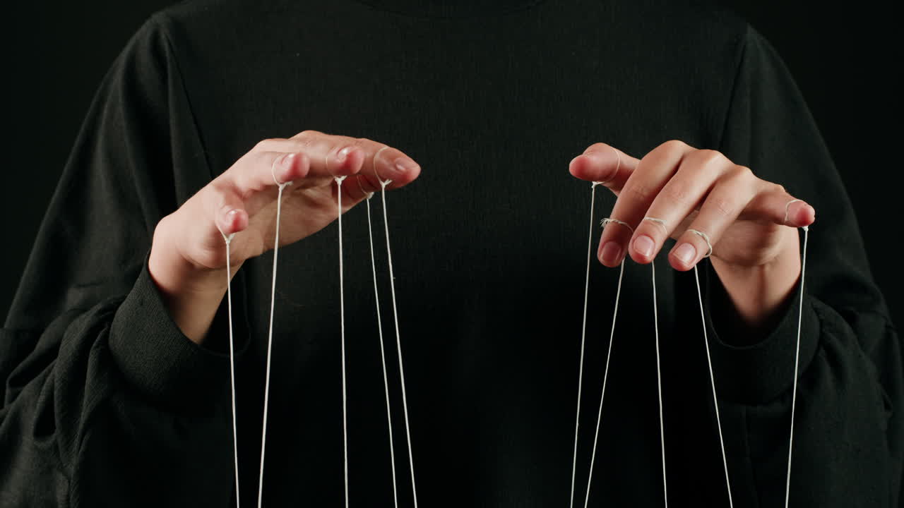 Human Hands Manipulating Puppet Strings for Control
