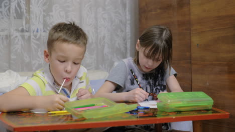 children drawing pictures and eating candies