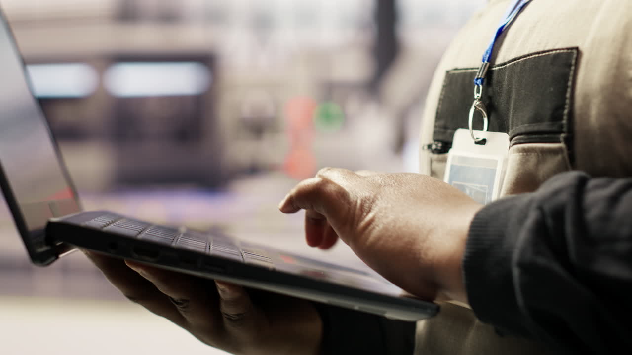 Vertical video Industrial plant expert overseeing installation process using laptop
