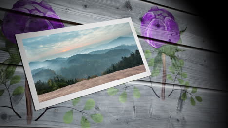 fotografía de paisaje con bosques y montañas contra la impresión floral sobre fondo de madera