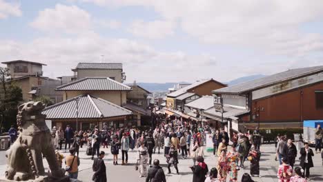 tourists overflow at kiyomizu-dera as they come dressed in kimonos with cameras, buying gifts and exploring