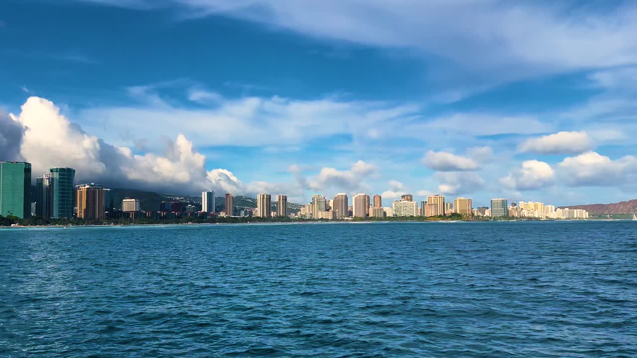 Oahu's cityscape from ocean, vibrant Honolulu under blue skies, tranquil water