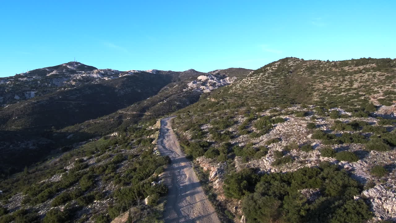 Witness the beauty of Penteli's gravel road during sunset