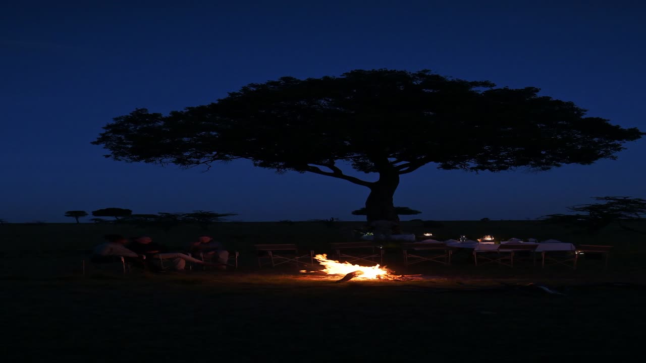 Fire at Night in the Bush on Africa Safari Holiday Vacation, Campfire at Night in Maasai Mara National Park on Luxury African Safari in Masai Mara in Kenya in Africa